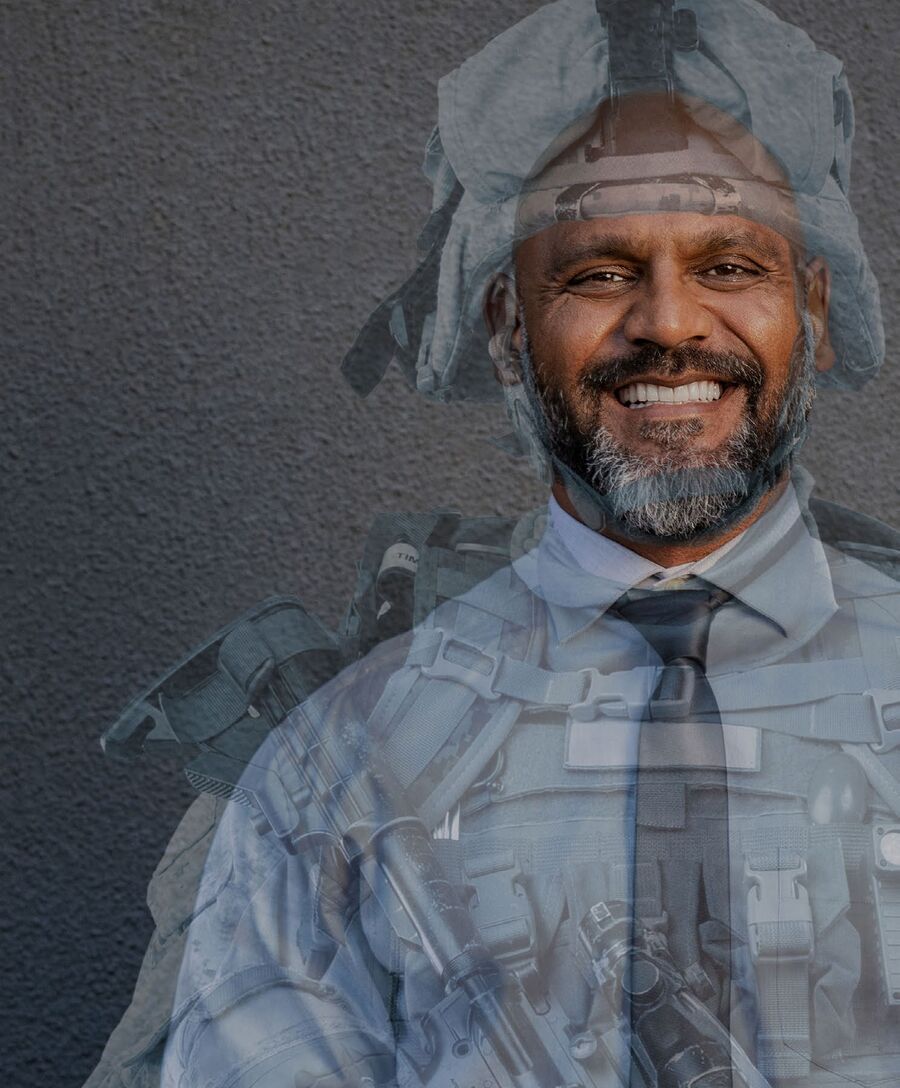 A smiling veteran in tactical gear.